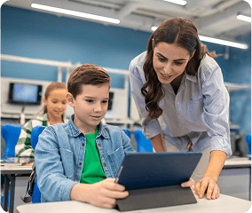 Teacher helping children with tablet